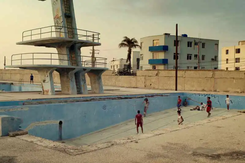 CUBA FIXER | Kids play at Parke Marti Sport Center in Havana inside an empty delapidated pool. Photo Credit: Dean Freeman